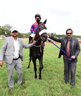 Moonlight Queen (Faiz up), winner of the SHIVANASAMUDRA PLATE (DIV-I) being led in by trainer Monnappa C D on Wednesday races at Mysore.